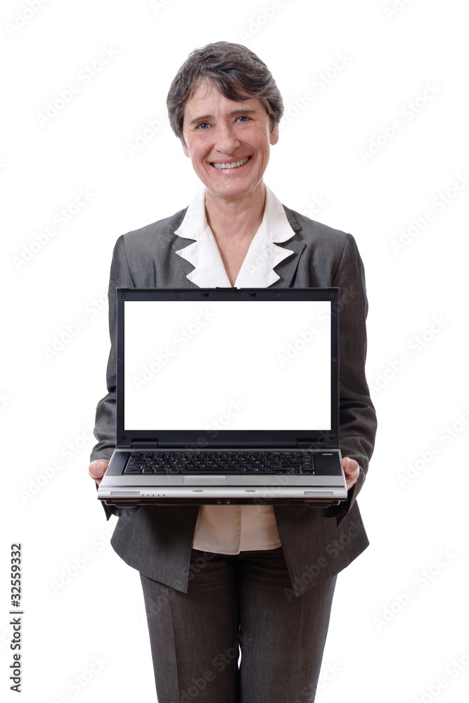 Smiling mature woman presenting laptop with empty screen Smiling mature woman presenting laptop with empty screen