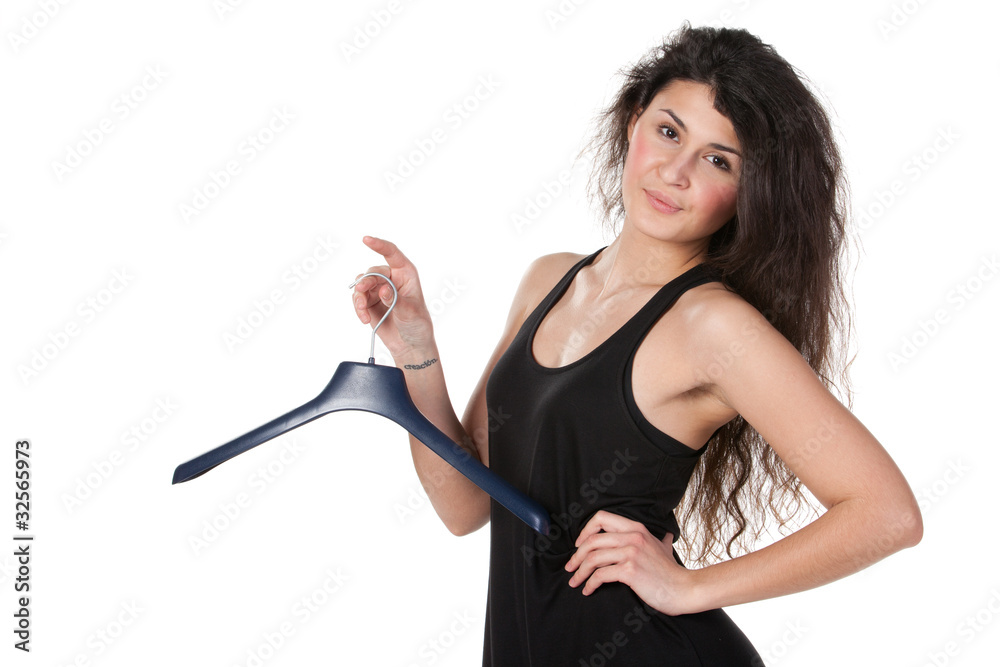Young woman handing clothes hanger on finger Young woman handing clothes hanger on finger