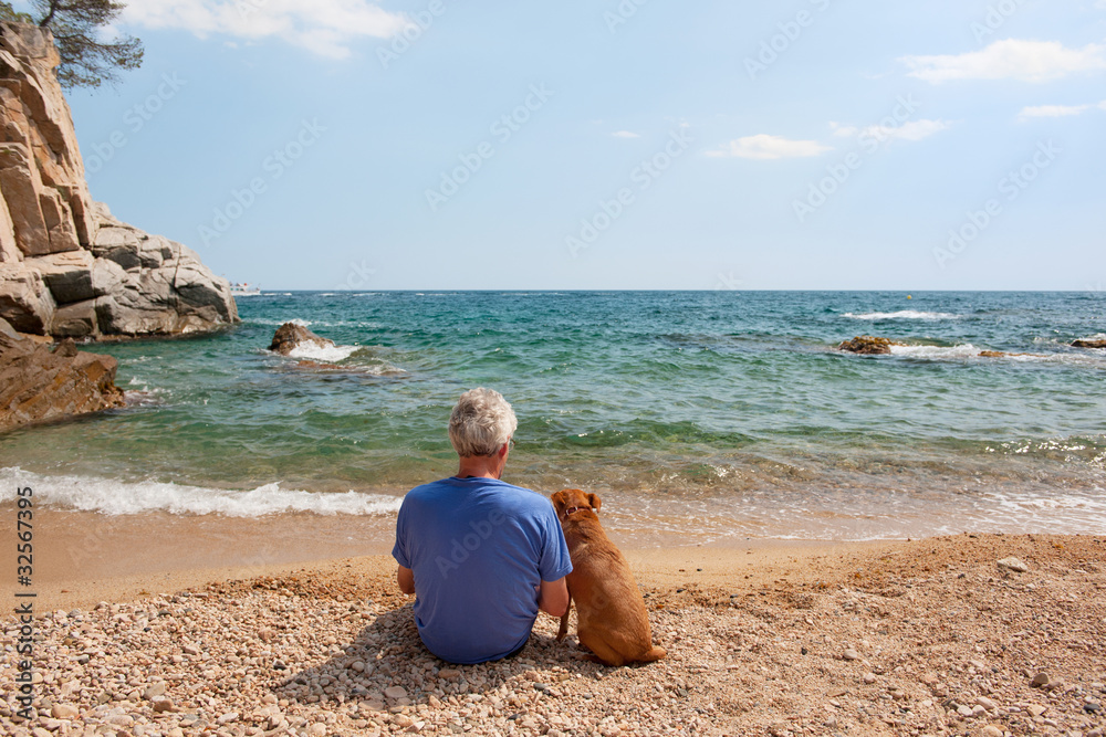 Man with his dog at the beach