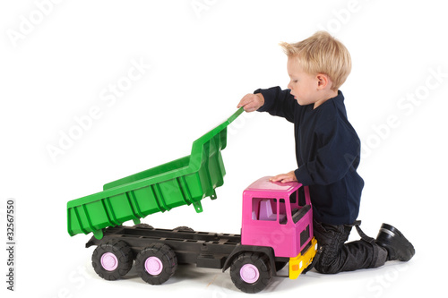 Little child playing with a truck