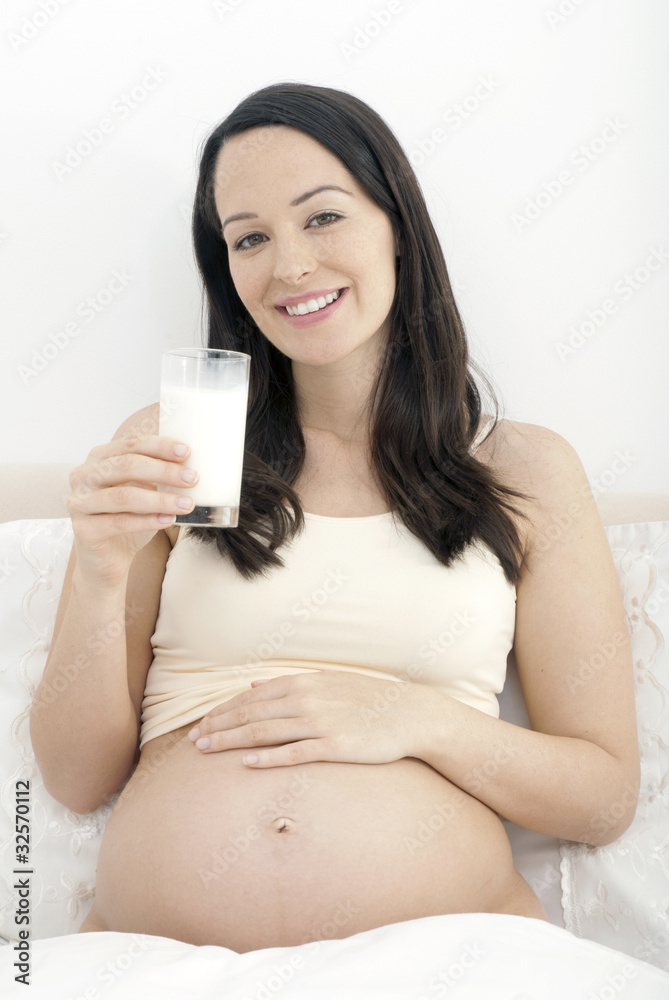 Pregnant woman enjoying glass of milk Pregnant woman enjoying glass of milk