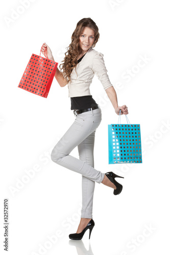 Portrait of young female holding paper-bags with purchases