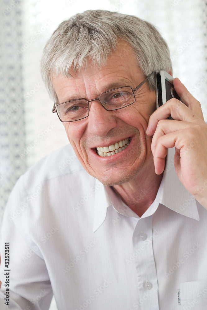 Portrait of an aged business man using phone