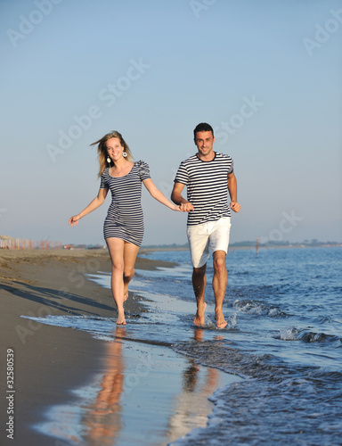 happy young couple have romantic time on beach