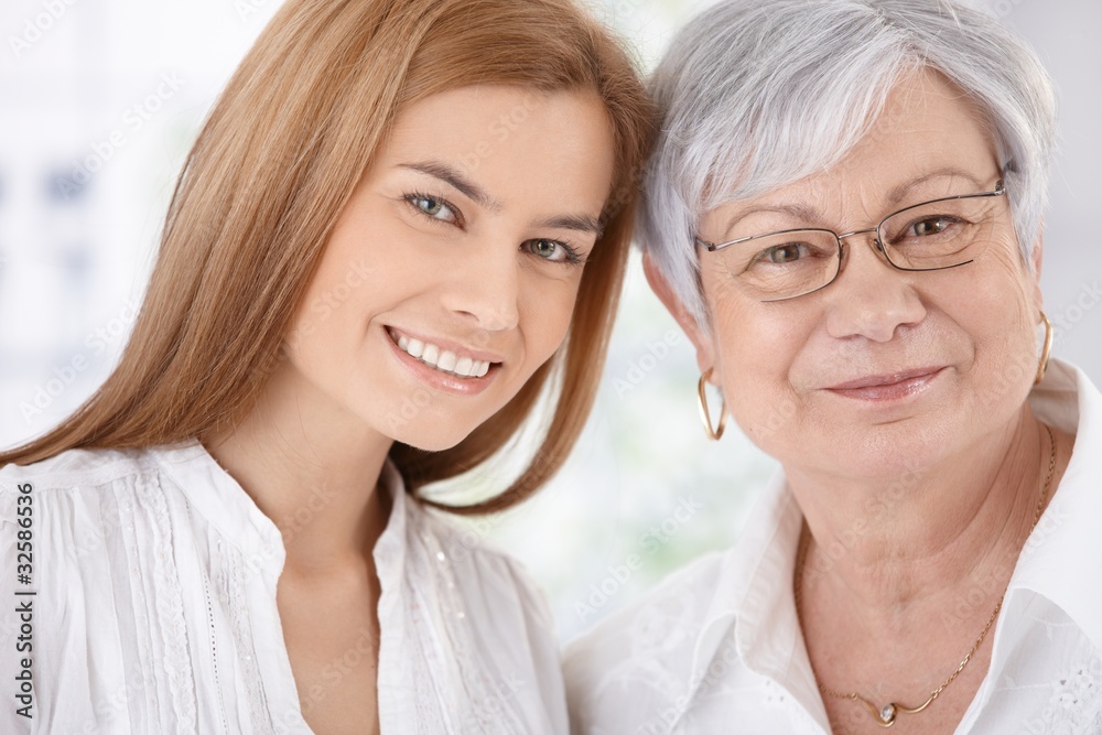 Closeup portrait of young woman and mother smiling Closeup portrait of young woman and mother smiling