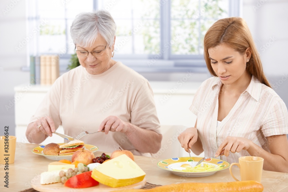 Mother and daughter having lunch at home Mother and daughter having lunch at home