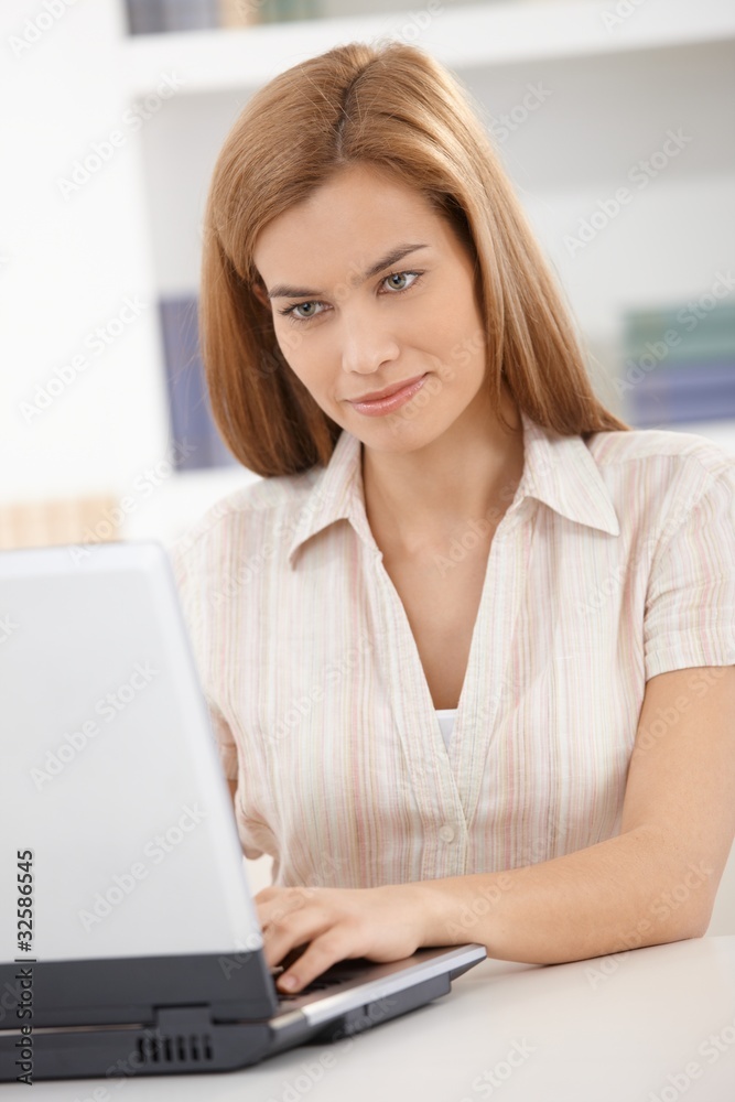 Portrait of young woman using laptop smiling Portrait of young woman using laptop smiling