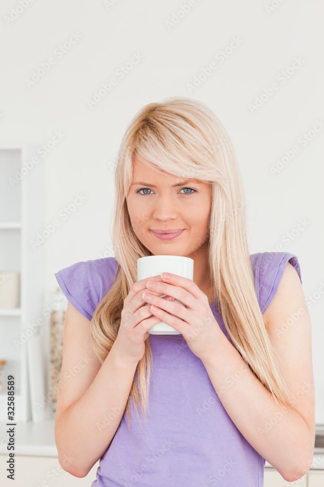 Attractive blonde female drinking hot drink Attractive blonde female drinking hot drink