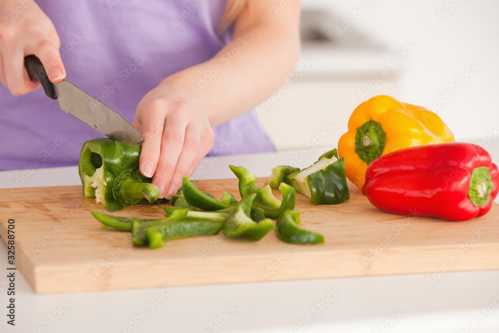 Woman cutting vegetables in modern kitchen interior Woman cutting vegetables in modern kitchen interior