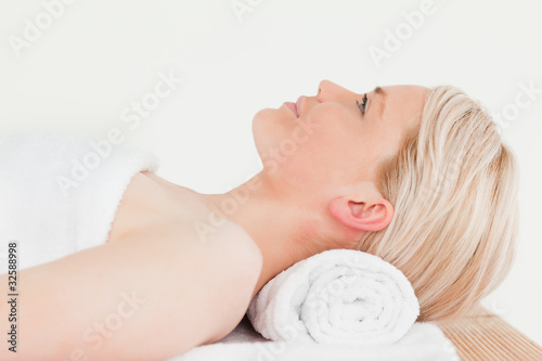Smiling blonde woman enjoying her treatment in a Spa centre