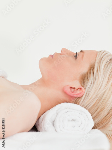 Releaxed blonde woman enjoying her treatment in a Spa centre