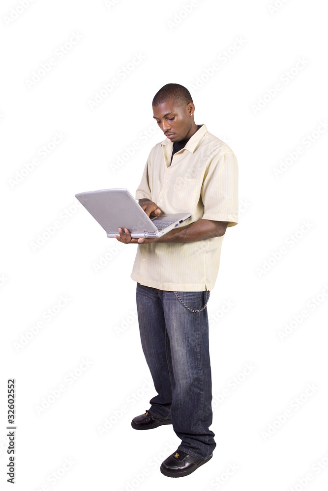 Young black man standing and working on laptop Young black man standing and working on laptop