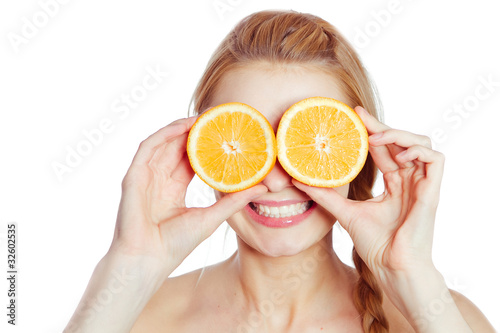 Young woman with oranges in her hands