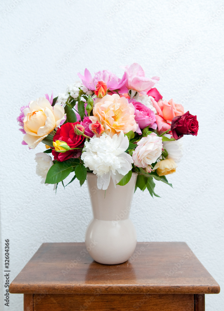 Colorful flower bouquet in front of white wall Colorful flower bouquet in front of white wall