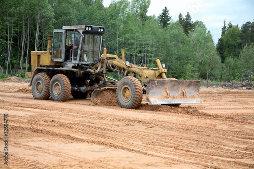 The grader clears away