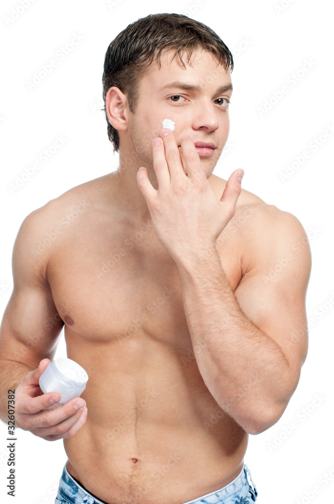 Man putting on cream lotion on face Man putting on cream lotion on face