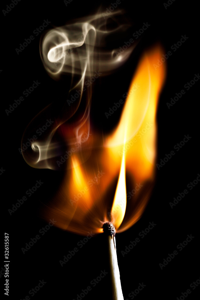 match burning on black background with smoke match burning on black background with smoke