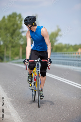 Fototapeta Naklejka Na Ścianę i Meble -  Professional  biker riding on race bike looking behind