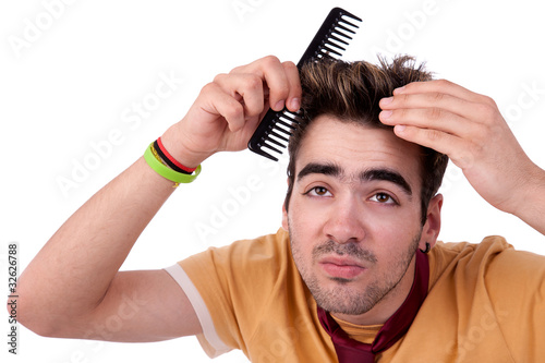young man combing his hair with a comb