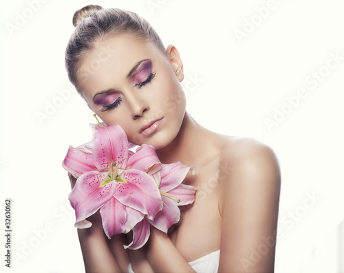 beautiful young sexy woman with flowers on white background