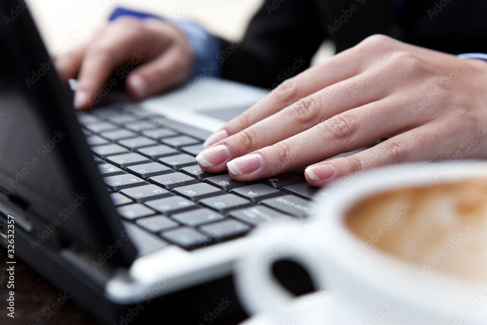 hands typing on lap top
