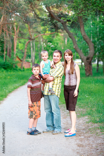 Couple giving and children outdoors © Tolchik