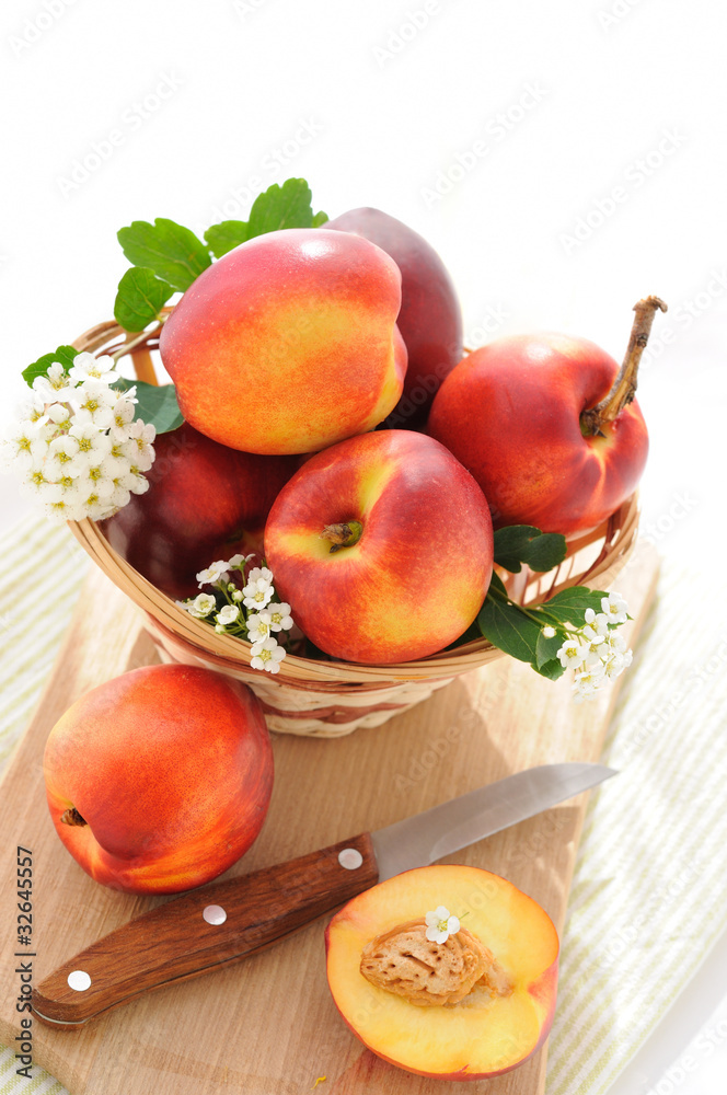 Fresh, ripe nectarines in a basket on board Fresh, ripe nectarines in a basket on board