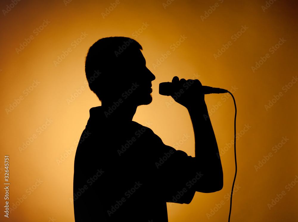 Silhouette of a young man in orange.