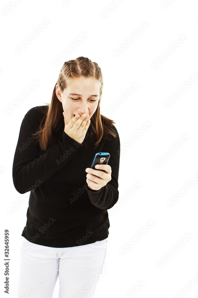 Surprised teen girl looking at the mobile phone in her hand Surprised teen girl looking at the mobile phone in her hand