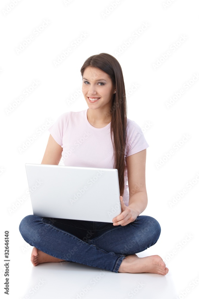 Smiling woman browsing internet on floor Smiling woman browsing internet on floor