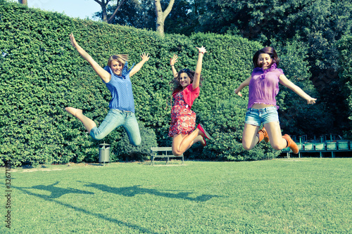 Happy Teenage Female Friends Jumping