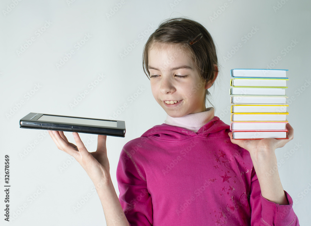 Teen girl holds electronic book and a stack of books