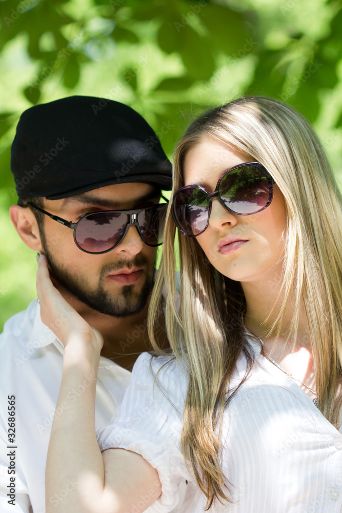 Attractive young couple posing outdoor at sunset in nature Attractive young couple posing outdoor at sunset in nature