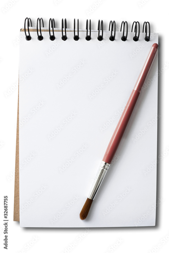 Brush handle in red on a white sketch book Brush handle in red on a white sketch book