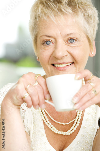 Senior woman sitting at the table in her home