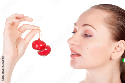 Pretty model holding radishes close to lips