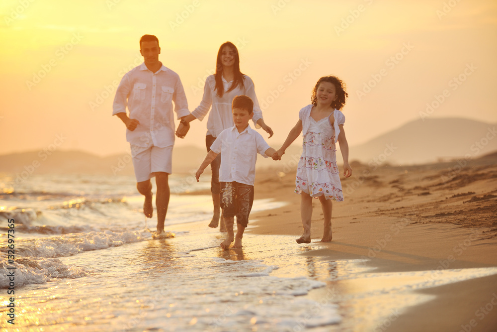 happy young family have fun on beach at sunset