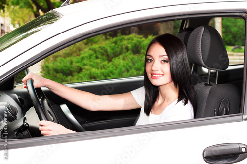 young brunette woman in new car
