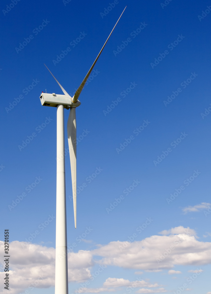 white wind turbine generating electricity on blue sky white wind turbine generating electricity on blue sky