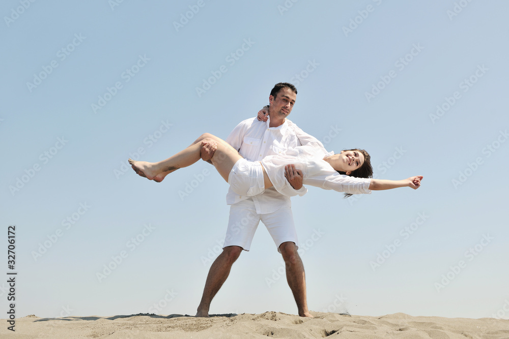 happy young couple have fun on beach happy young couple have fun on beach