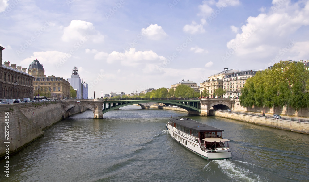 Naklejka premium Passenger ship boat sails on the river Seine. Paris