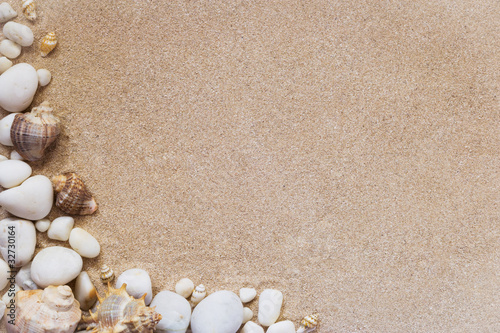 sea shells and stones with sand as background