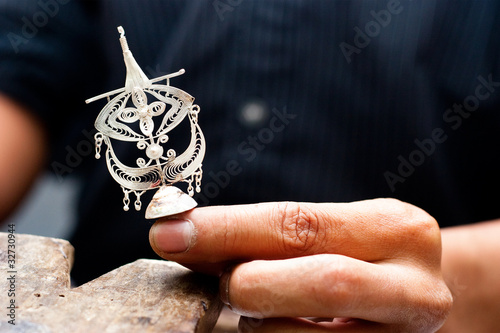 Crafter Hand Holding a traditional Wau Bulan Kite Silver Filligr