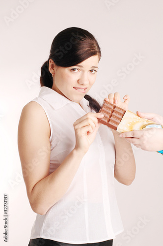 Young beautiful woman with chocolate bar