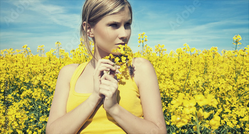 Young woman relaxing on a gold meadow