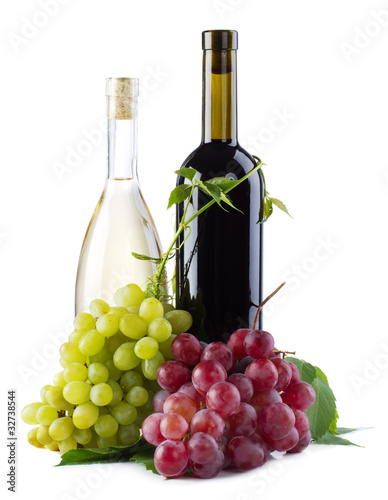 Bottles of red and white wine with grapes