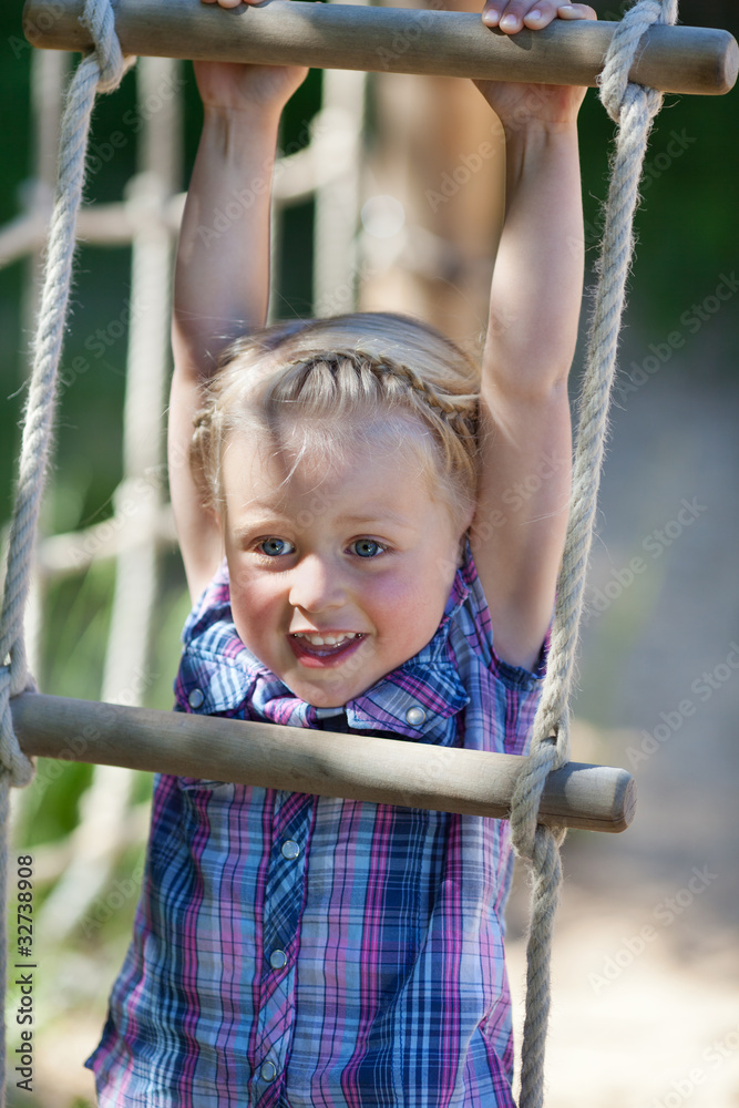 lachendes kind hängt an einer strickleiter lachendes kind hängt an einer strickleiter