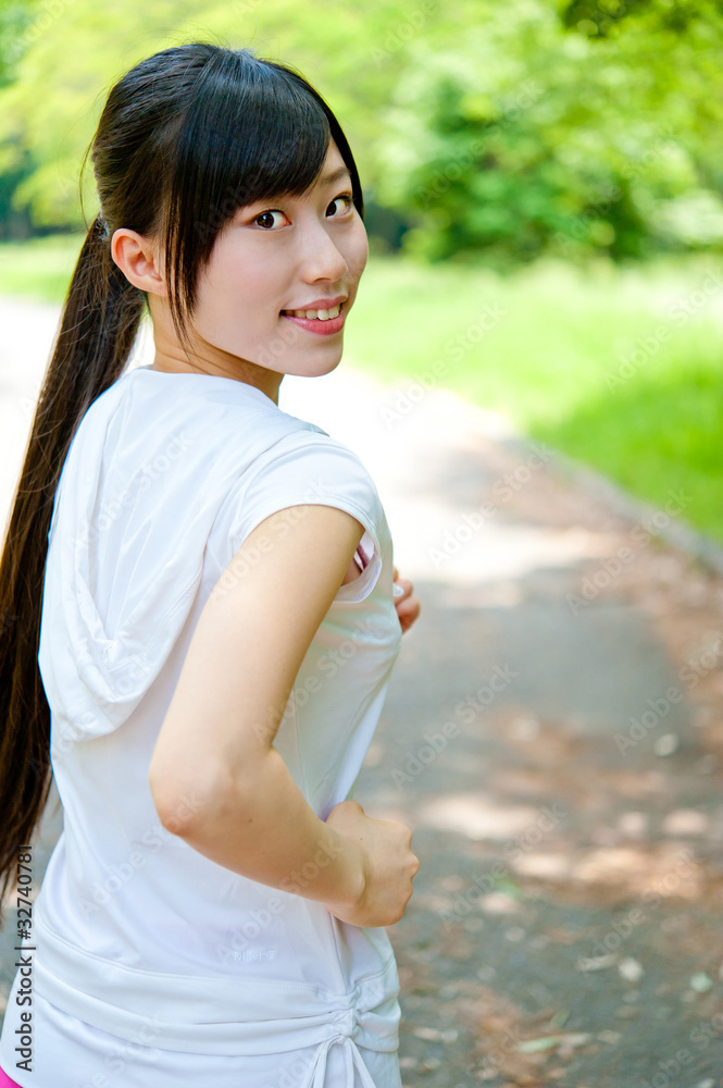 beautiful asian woman jogging in the park