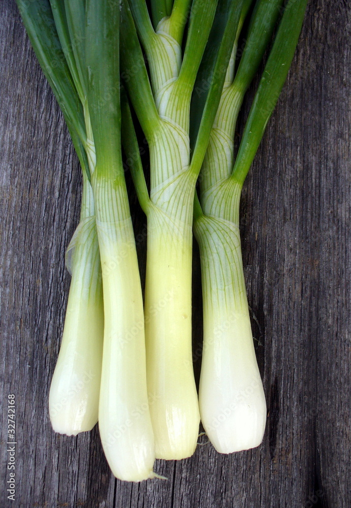 Bunch of green onion on a wooden background Bunch of green onion on a wooden background