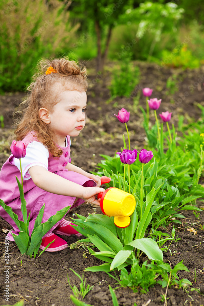 Girl watering flowers Girl watering flowers